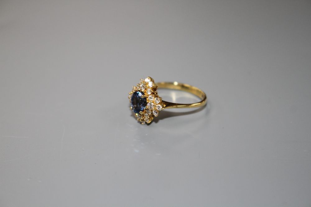 A modern 18ct gold, sapphire and diamonds set quatrefoil shaped cluster ring, size M, gross 4 grams